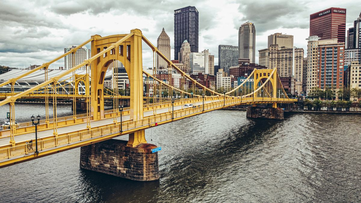 The yellow Roberto Clemente Bridge leading to downtown Pittsburgh